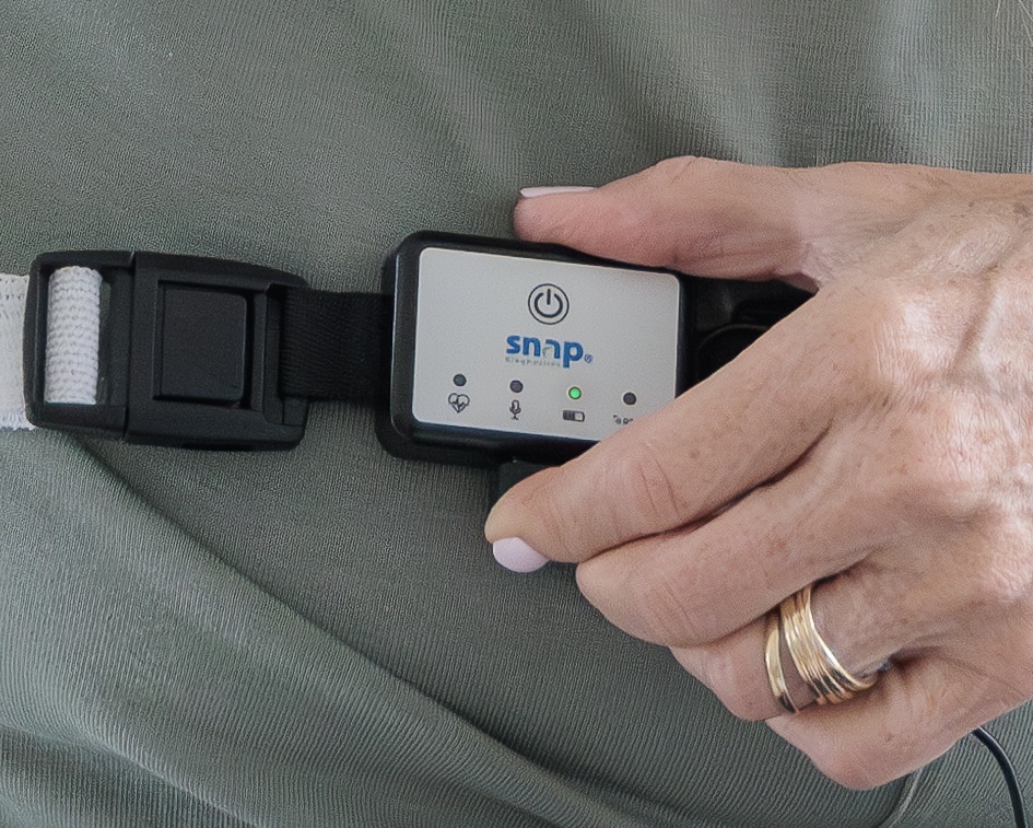 A close-up of the Snap SAM recorder power button being pressed